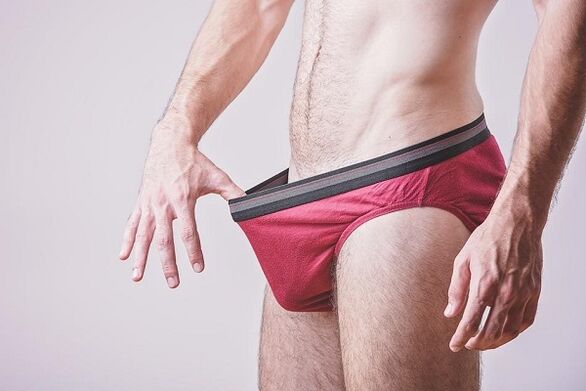 a man looks inside his underwear and wants to enlarge his penis
